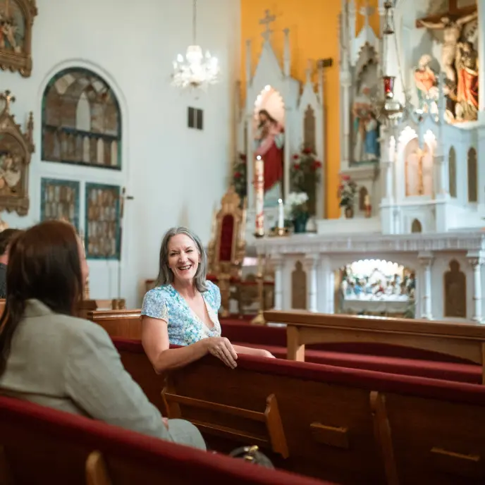 Women in a church talking and smiling